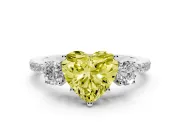 Fancy Yellow Heart Cut Diamond Three-Stone Ring Set in White gold with Pavé Band and Graduated Sides