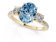 Fancy Blue Oval Cut Diamond Three-Stone Ring Set in Yellow gold with Pavé Band and Graduated Sides