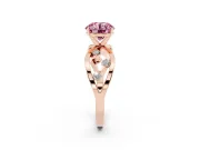 Fancy Pink Round Cut Diamond Solitaire Ring Set in Rose gold with Side Stones on Criss-Cross Band and Prong Setting