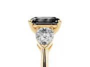 Fancy Black Three-Stone Emerald Cut Diamond Ring Set in Yellow gold with Pear Side Stones and Prong Setting