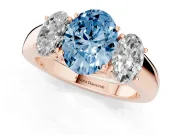 Fancy Blue Three-Stone Oval Cut Diamond Ring Set in Rose gold with Matching Prong Settings and Plain Band