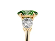 Fancy Green Three-Stone Oval Cut Diamond Ring Set in Yellow gold with Pear Side Stones and Prong Setting