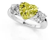 Fancy Yellow Heart Cut Diamond Three-Stone Ring Set in Platinum with Bold Center and Classic Band