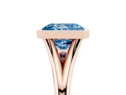 Fancy Blue Bezel Set Radiant Cut Diamond Solitaire Ring Set in Rose gold with Tapered Band