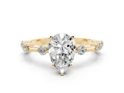Pear Cut Diamond Solitaire Ring Set in Yellow gold with Bezel Set Side Stones and Prong Setting
