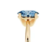 Fancy Blue Oval Cut Diamond Solitaire Ring Set in Yellow gold with Prong Setting on a Plain Round Band