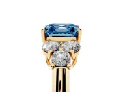Fancy Blue Asscher Cut Diamond Cluster Ring Set in Yellow gold with Round Accent Stones and Prong Setting on a Plain Band