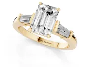Emerald Cut Diamond Solitaire Ring Set in Yellow gold with Tapered Baguette Accents and Prong Setting