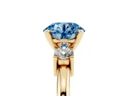 Fancy Blue Three-Stone Round Cut Diamond Ring Set in Yellow gold with Prong Setting and Plain Band