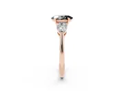 Fancy Black Three-Stone Oval Cut Diamond Ring Set in Rose gold with Pear Side Stones and Prong Setting