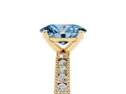 Fancy Blue Oval Cut Diamond Solitaire Ring Set in Yellow gold with Slim Pavé Band and Prong Setting