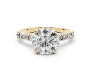 Round Cut Diamond Solitaire Set in Yellow gold with Side Baguettes and Channel Set Band