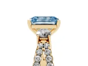 Fancy Blue Emerald Cut Diamond Three-Stone Ring Set in Yellow gold with Pavé Split Shank and Prong Setting