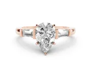 Pear Cut Diamond Solitaire Ring Set in Rose gold with Tapered Baguette Accents and Prong Setting