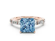 Fancy Blue Princess Cut Diamond Solitaire Set in Rose gold with Side Baguettes and Channel Set Band