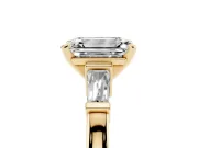 Emerald Cut Diamond Solitaire Ring Set in Yellow gold with Tapered Baguette Accents and Prong Setting