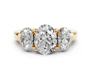 Oval Cut Diamond Three-Stone Ring Set in Yellow gold with Polished Band and Prong Setting