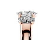 Three-Stone Oval Cut Diamond Ring Set in Rose gold with Matching Prong Settings and Plain Band