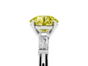 Fancy Yellow Round Cut Diamond Solitaire Ring Set in White gold with Tapered Baguette Side Stones and Prong Setting