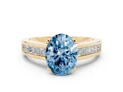 Fancy Blue Oval Cut Diamond Solitaire Ring Set in Yellow gold with Channel-Set Band and Prong Setting