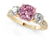 Fancy Pink Cushion Cut Diamond Three-Stone Ring Set in Yellow gold with Round Side Stones and Pavé Band