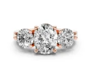 Oval Cut Diamond Three-Stone Ring Set in Rose gold with Prong Setting and Classic Band