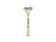 Fancy Blue Pear Cut Diamond Solitaire Ring Set in Yellow gold with Bezel Set Side Stones and Prong Setting