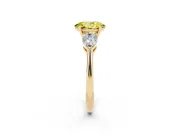 Fancy Yellow Three-Stone Oval Cut Diamond Ring Set in Yellow gold with Pear Side Stones and Prong Setting