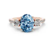 Fancy Blue Oval Cut Diamond Three-Stone Ring Set in Rose gold with Pavé Band and Graduated Sides