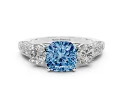 Fancy Blue Cushion Cut Diamond Three-Stone Ring Set in Platinum with Round Side Stones and Pavé Band