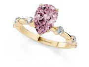 Fancy Pink Pear Cut Diamond Solitaire Ring Set in Yellow gold with Bezel Set Side Stones and Prong Setting