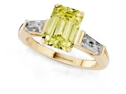 Fancy Yellow Emerald Cut Diamond Solitaire Ring Set in Yellow gold with Tapered Baguette Side Stones and Prong Setting