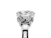 Oval Cut Diamond Three-Stone Ring Set in Platinum with Polished Band and Prong Setting