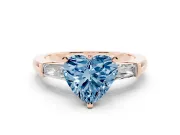 Fancy Blue Heart Cut Diamond Solitaire Ring Set in Rose gold with Tapered Baguette Side Stones and Prong Setting