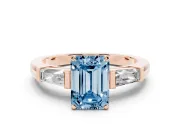 Fancy Blue Emerald Cut Diamond Solitaire Ring Set in Rose gold with Tapered Baguette Side Stones and Prong Setting