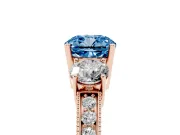 Fancy Blue Cushion Cut Diamond Three-Stone Ring Set in Rose gold with Round Side Stones and Pavé Band