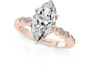 Marquise Cut Diamond Solitaire Engagement Ring Set in Rose gold with Bezel Accents on Beaded Band
