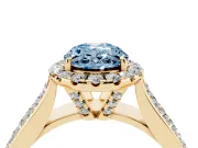 Fancy Blue Oval Cut Diamond Halo Ring Set in Yellow gold with Pavé Band and Raised Center Setting