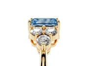 Fancy Blue Emerald Cut Diamond Solitaire Ring Set in Yellow gold with Cluster Accents on Each Side