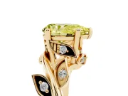 Fancy Yellow Pear Cut Diamond Solitaire Twist Engagement Ring Set in Yellow gold with Pavé Leaf Accents
