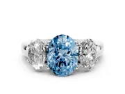 Fancy Blue Oval Cut Diamond Three-Stone Ring Set in White gold with Bold Center and Classic Band
