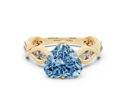 Fancy Blue Heart Cut Diamond Twist Band Solitaire Ring Set in Yellow gold with Leaf Prong Setting and Accent Stones