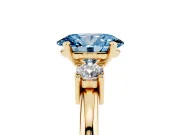 Fancy Blue Three-Stone Oval Cut Diamond Ring Set in Yellow gold with Prong Setting and Plain Band