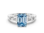 Fancy Blue Emerald Cut Diamond Solitaire Ring Set in Platinum with Tapered Baguette Side Stones and Prong Setting