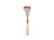Fancy Pink Three-Stone Heart Cut Diamond Ring Set in Rose gold with Pear Side Stones and Prong Setting