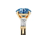 Fancy Blue Round Cut Diamond Solitaire Ring Set in Yellow gold with Tapered Baguette Side Stones and Prong Setting