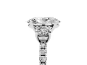 Oval Cut Diamond Three-Stone Ring Set in Silver with Pavé Band and Graduated Sides