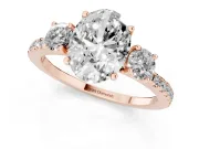 Oval Cut Diamond Three-Stone Ring Set in Rose gold with Pavé Band and Graduated Sides