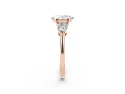 Three-Stone Oval Cut Diamond Ring Set in Rose gold with Pear Side Stones and Prong Setting