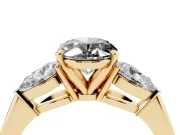Fancy Black Three-Stone Oval Cut Diamond Ring Set in Yellow gold with Pear Side Stones and Prong Setting